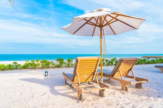 https://en.sthteam.com/wp-content/uploads/2021/10/umbrella-deck-chair-around-outdoor-swimming-pool-hotel-resort-with-sea-ocean-beach-coconut-palm-tree_74190-14087.jpg